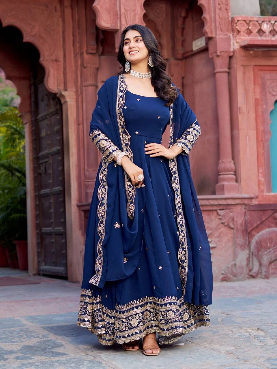 The flowing silhouette of the gown adds grace and movement to the overall appearance.