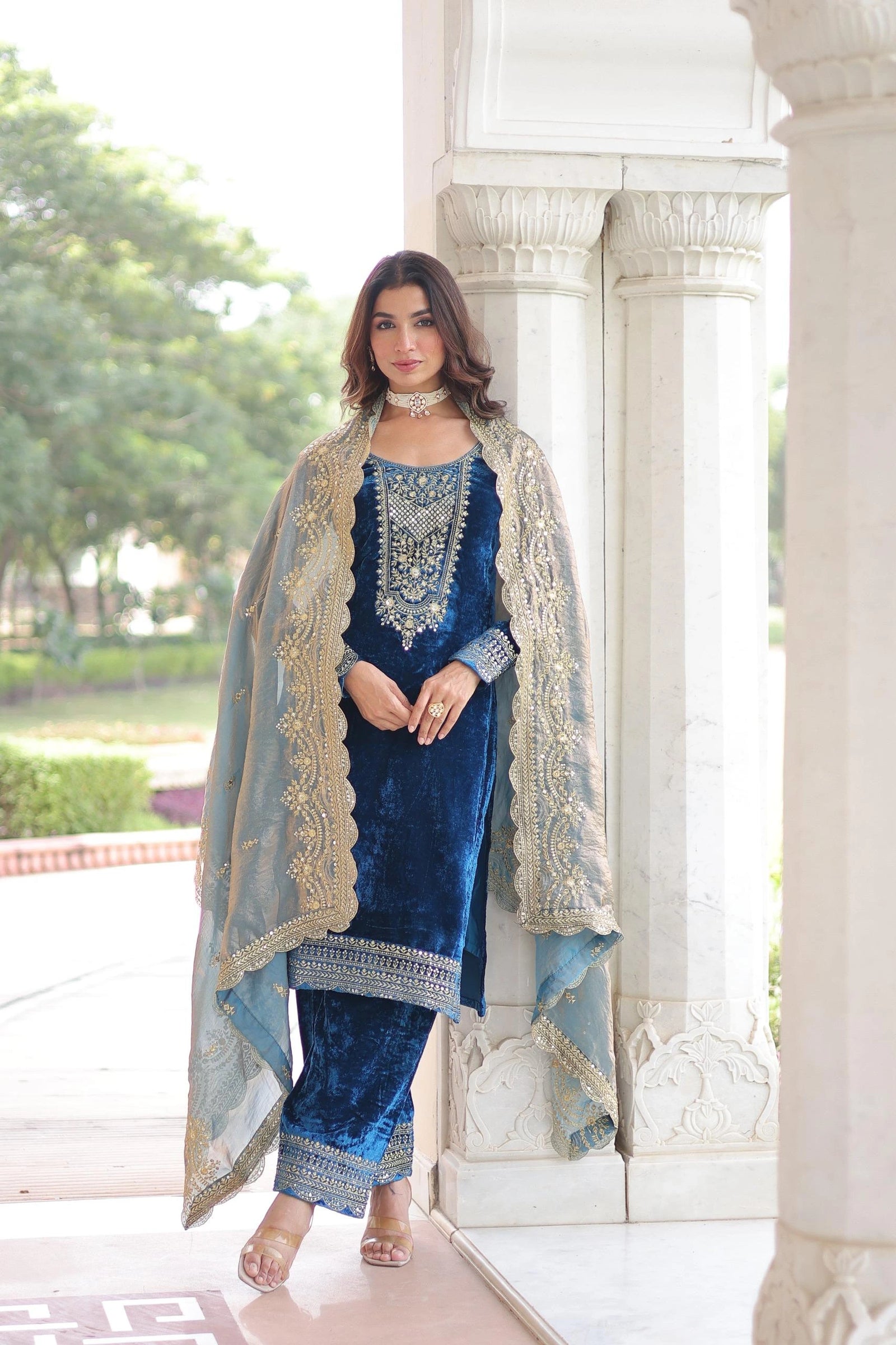 Woman in a blue traditional outfit with a white background