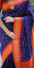 Navy blue saree with orange border and gold jewelry