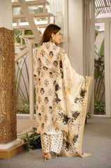Woman in a traditional outfit standing in an indoor setting with decorative elements.