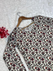 Floral-patterned fabric on a hanger with a textured white background