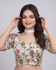Woman wearing a floral blouse against a plain background