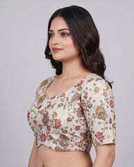 Woman wearing a floral blouse against a plain background