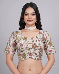 Woman wearing a floral blouse against a gray background