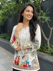 Woman wearing a white blouse with colorful patterns outdoors