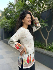 Woman wearing a traditional outfit with colorful sleeves in an outdoor setting