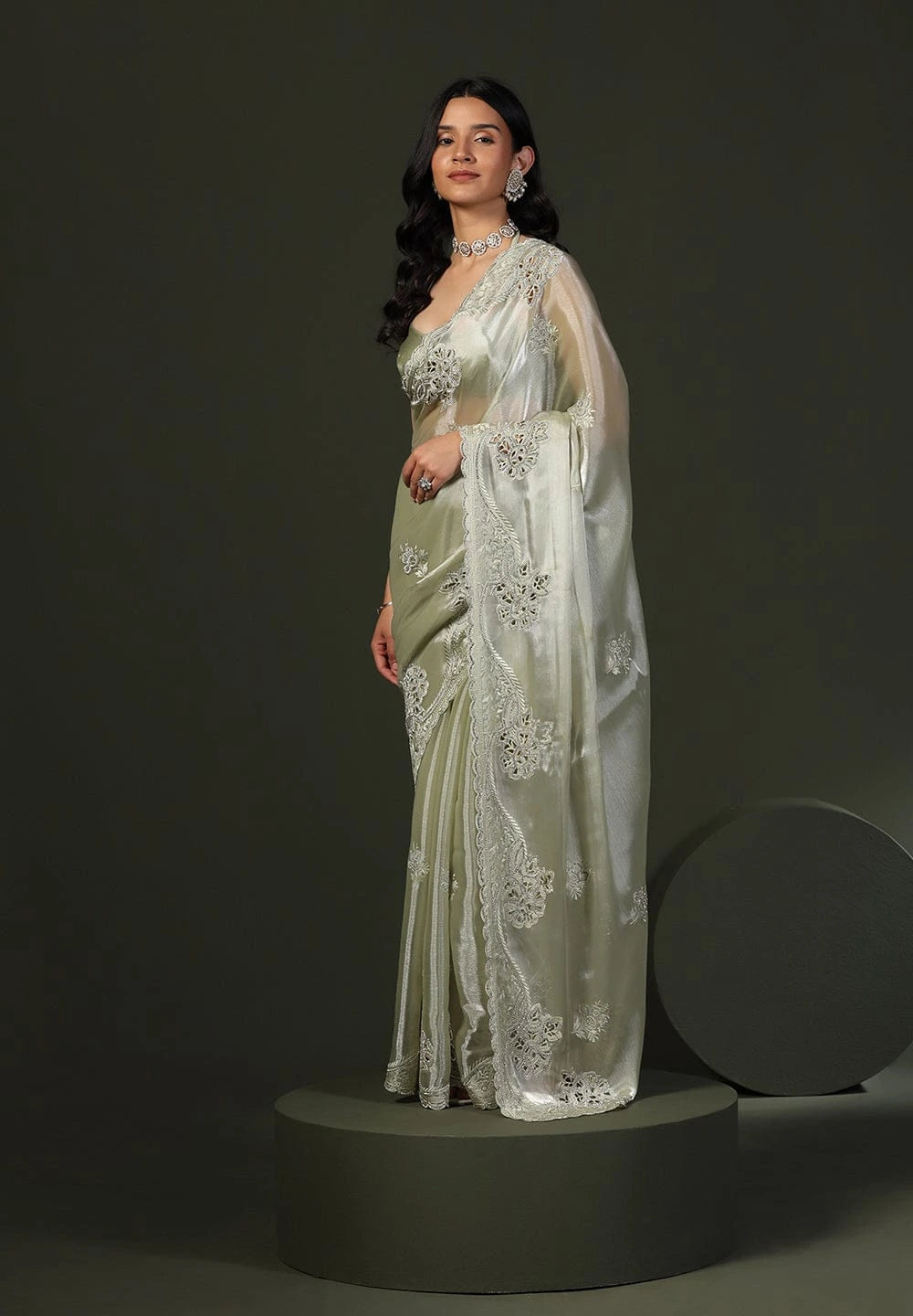 Model wearing pastel silk saree with intricate floral embroidery