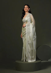 Model wearing pastel silk saree with intricate floral embroidery