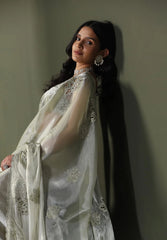 Fashion model showcasing a soft green designer saree