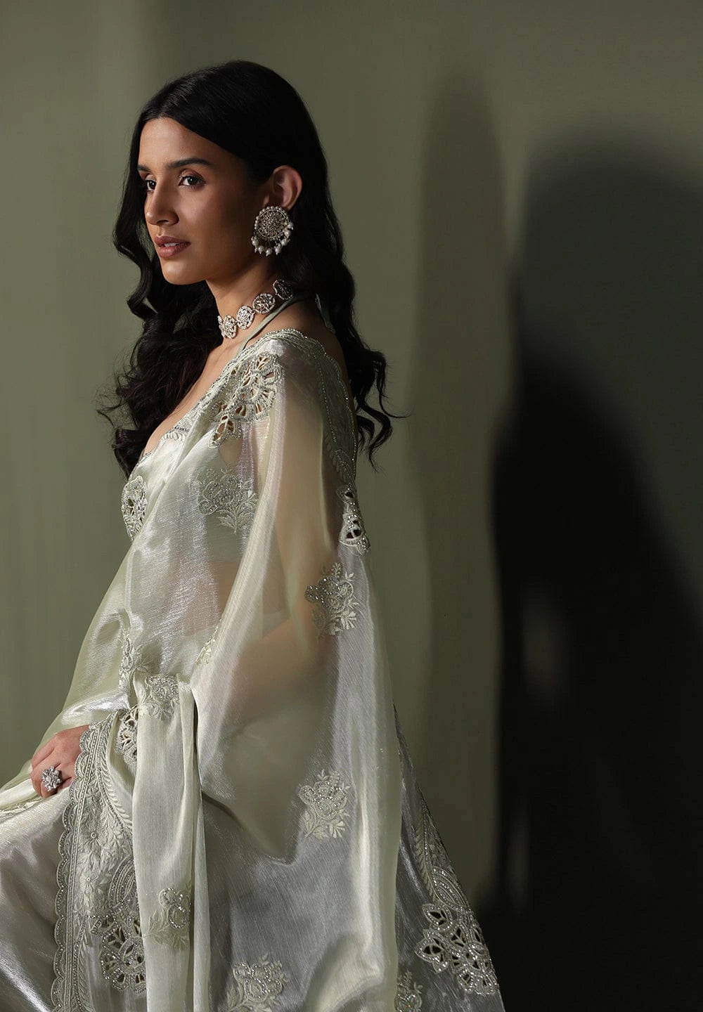 Woman in a white embroidered outfit with a blurred background
