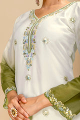 White and green embroidered traditional outfit with floral patterns