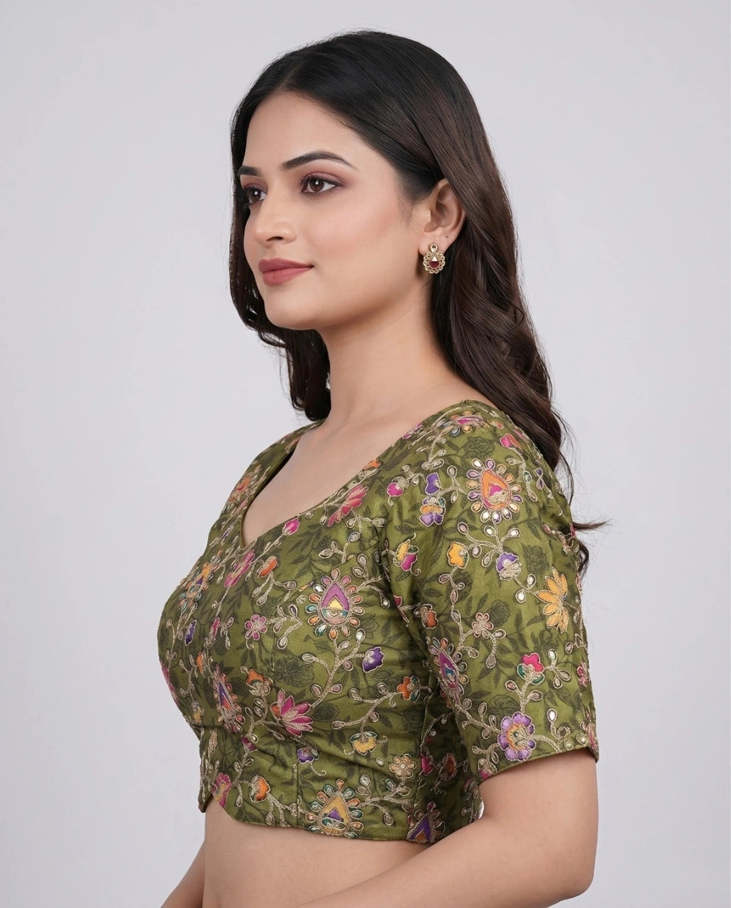 Woman wearing a green floral blouse against a white background