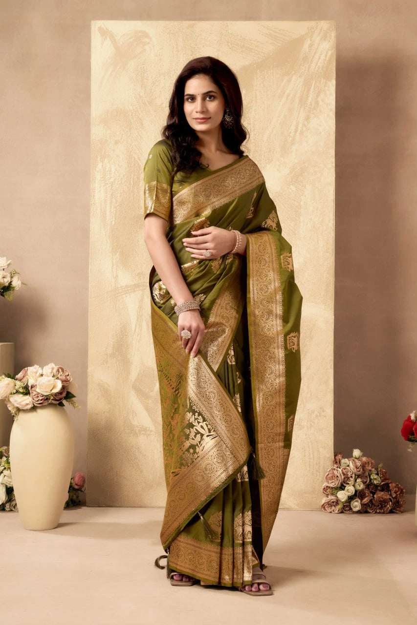 Woman wearing a green and gold saree with floral decorations in the background