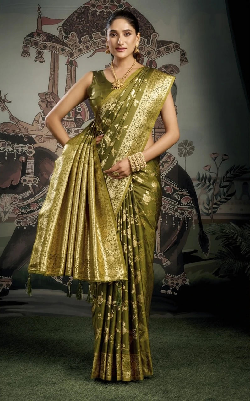 Woman wearing a gold saree with a traditional backdrop