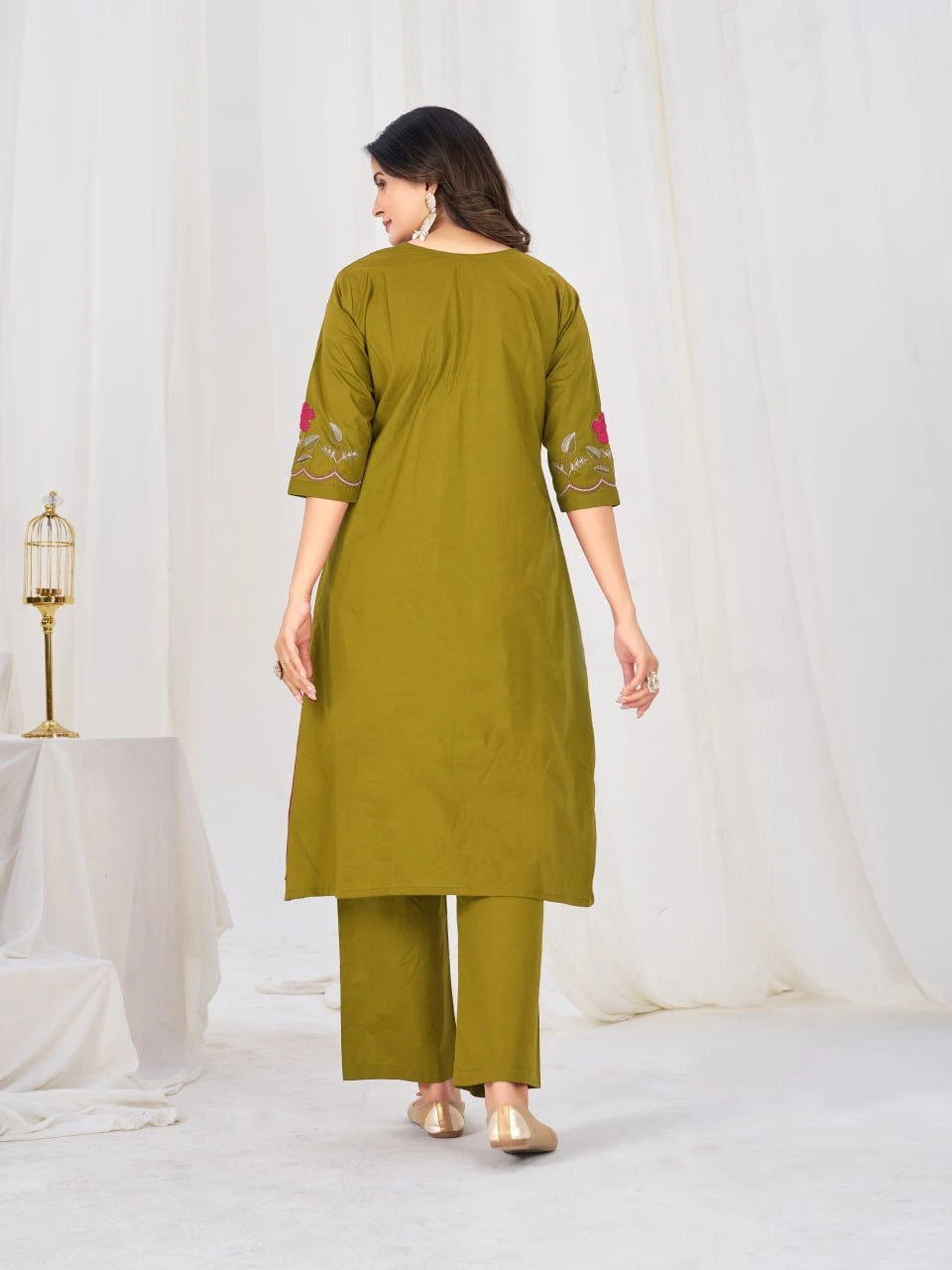 Elegant traditional outfit in refreshing green tones, highlighted by floral embroidery, pleated design, and coordinated bottoms.
