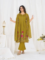 Woman wearing a green traditional outfit with floral patterns on a white background