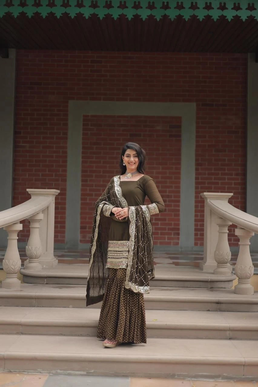 Woman in traditional attire standing on steps with a brick wall background