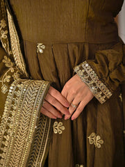 Brown garment with gold embroidery and a ring on a finger