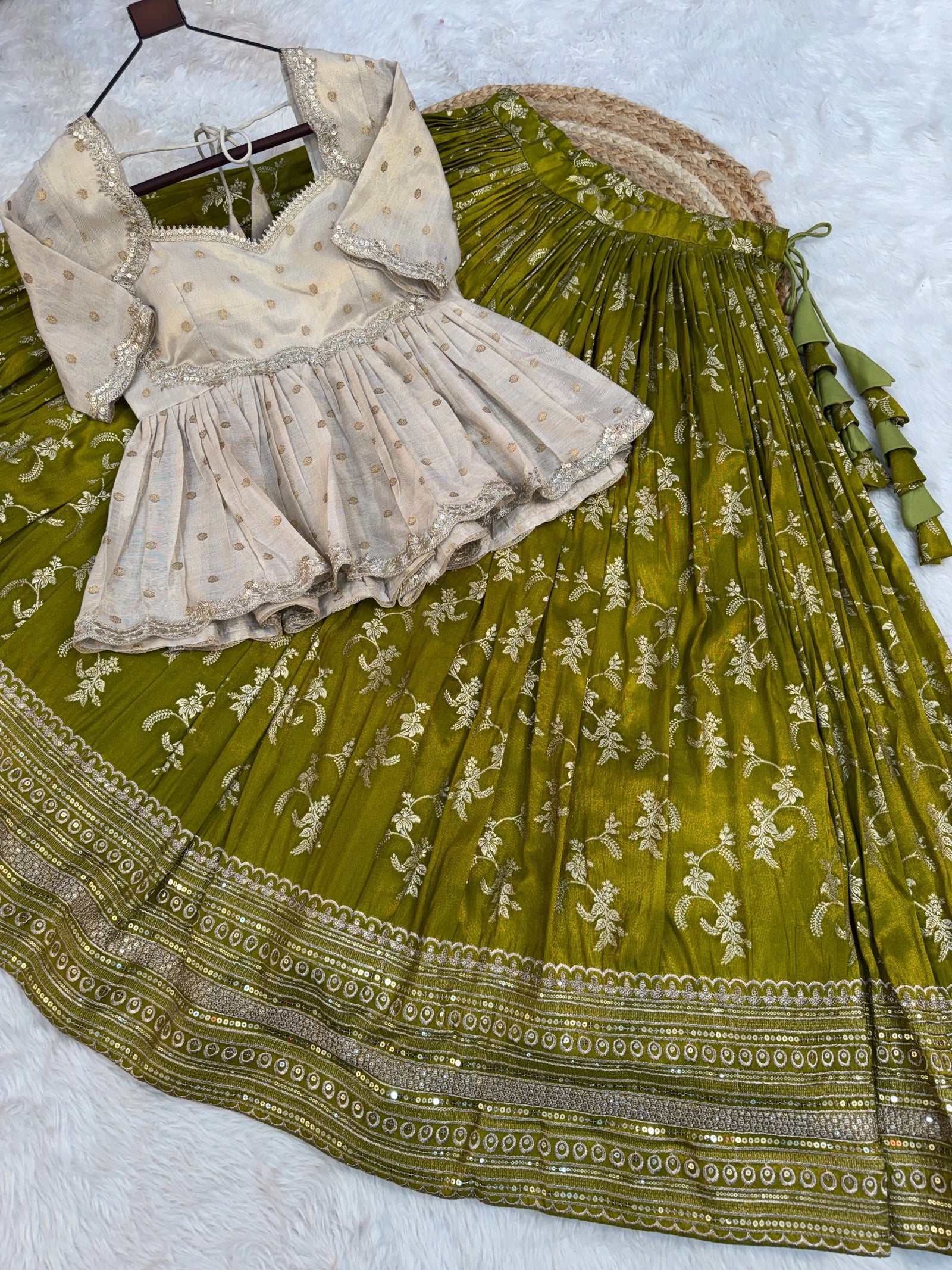 Green embroidered saree with a white blouse on a light gray background