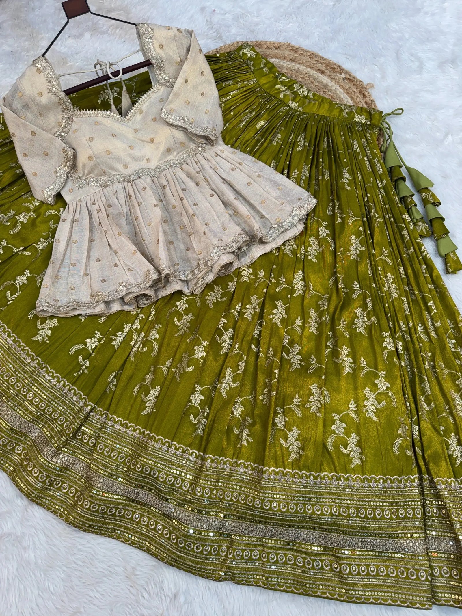 Green embroidered saree with a white blouse on a light gray background
