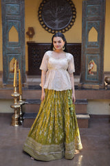 Woman in a traditional outfit standing in a decorated room with decorative elements.