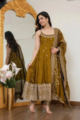 Woman in a mustard yellow traditional outfit standing in front of a mirror.