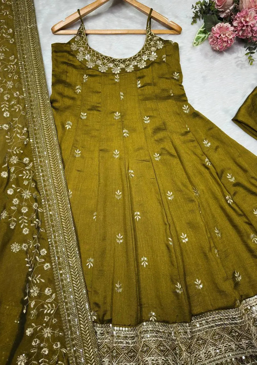 Green embroidered traditional outfit with a dupatta on a white background