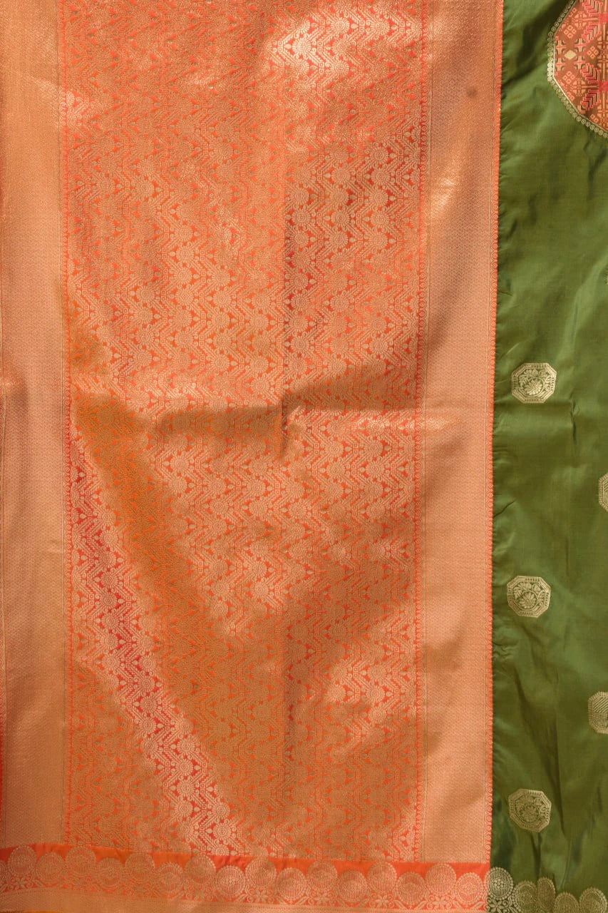 Close-up of a pink fabric with intricate patterns and a green fabric with floral patterns.