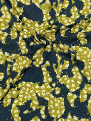 Fabric with green floral pattern on a dark blue background