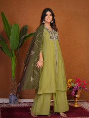 Woman in a green traditional outfit with a brown background