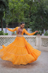 Woman in a bright orange traditional outfit dancing outdoors.