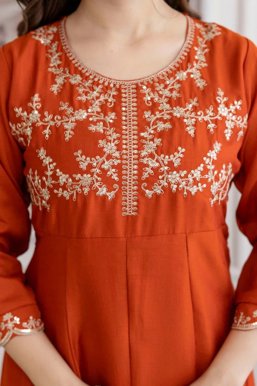 Orange kurta with white embroidery on a plain background