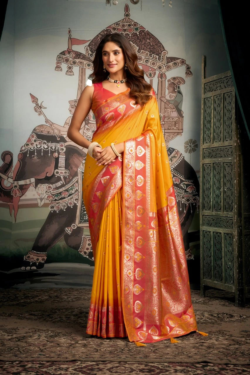 Woman wearing a yellow and pink saree with a decorative background