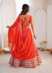 Woman in a bright red traditional outfit with a matching dupatta in a minimalistic setting.