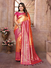 Woman wearing a traditional saree with a pink and orange design in an indoor setting.