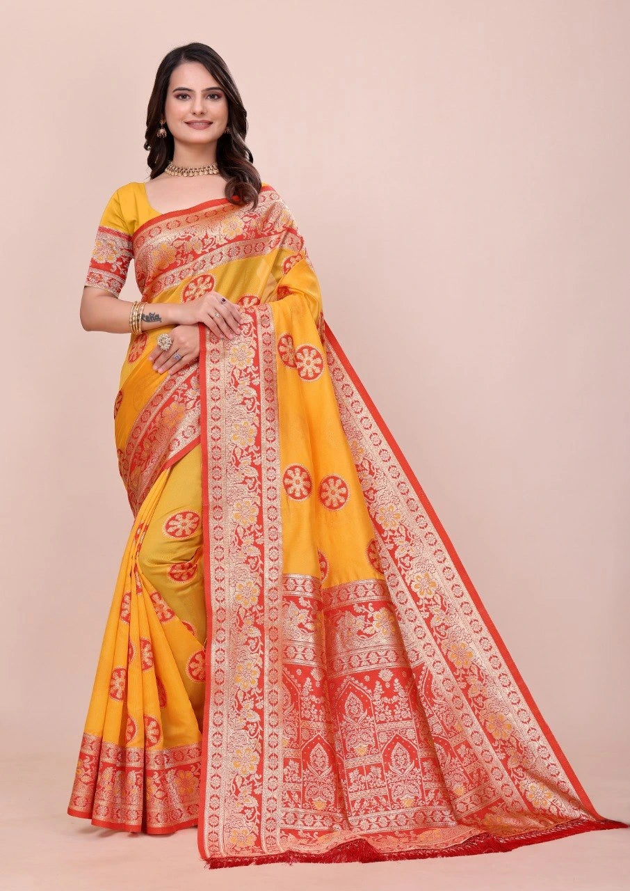 Woman wearing a yellow saree with red and white patterns on a beige background