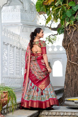 Elegant woman wearing a floral print lehenga with embroidered blouse and contrasting dupatta in a heritage palace setting.