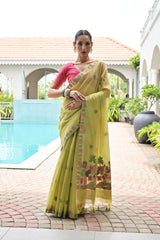 Woman in a yellow saree standing by a poolside