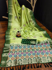 Green saree with intricate patterns on a wooden surface