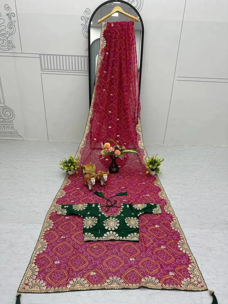 Flat lay of Pink Gota Patti Saree with bandhani print and zari border