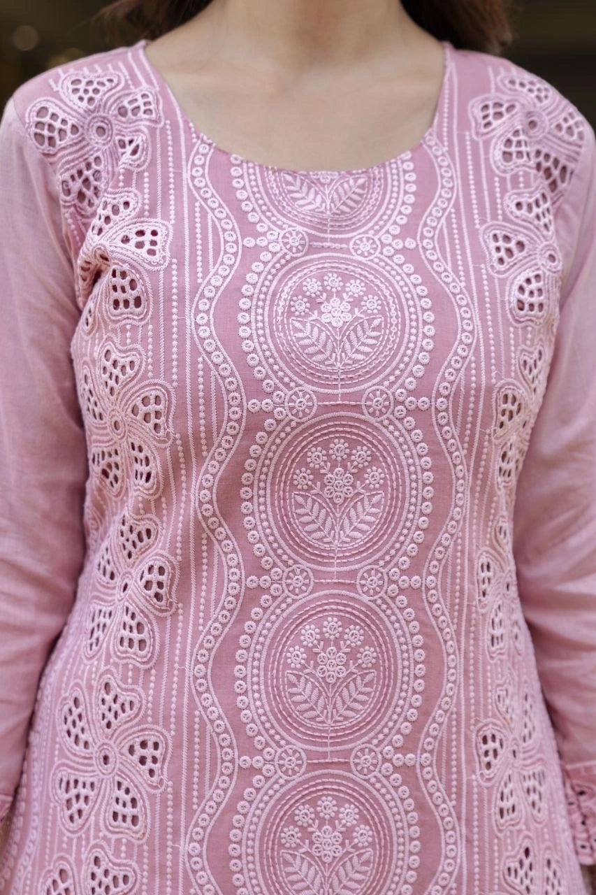 Pink embroidered traditional outfit with intricate patterns