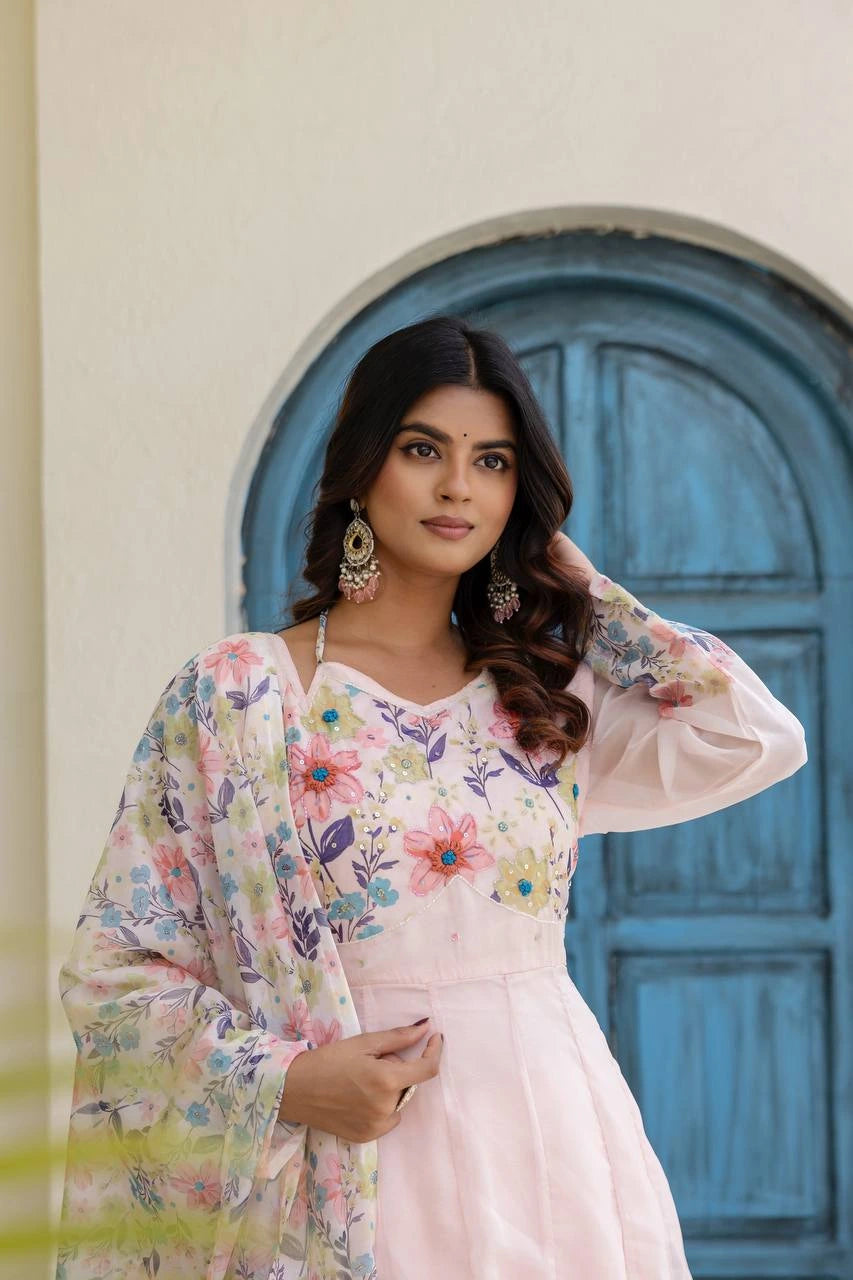 Fashionable pastel pink floral Anarkali gown with elegant silhouette and timeless ethnic elegance.