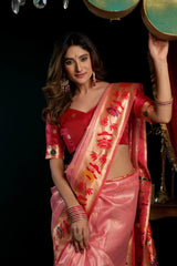 Woman in a pink saree with red blouse against a dark background