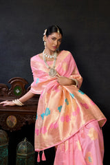 Woman in a traditional pink saree with a dark background