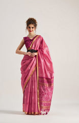 Woman wearing a pink saree with a white background
