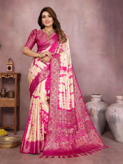 Woman wearing a pink and white saree with a neutral background