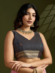 Woman wearing a traditional outfit with jewelry against a green background