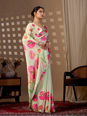 Woman wearing a floral saree in a room with a checkered wall and a chair.