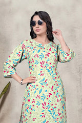 Woman wearing a colorful floral dress with sunglasses on a neutral background