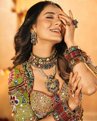 Woman in traditional attire with elaborate jewelry against a warm background